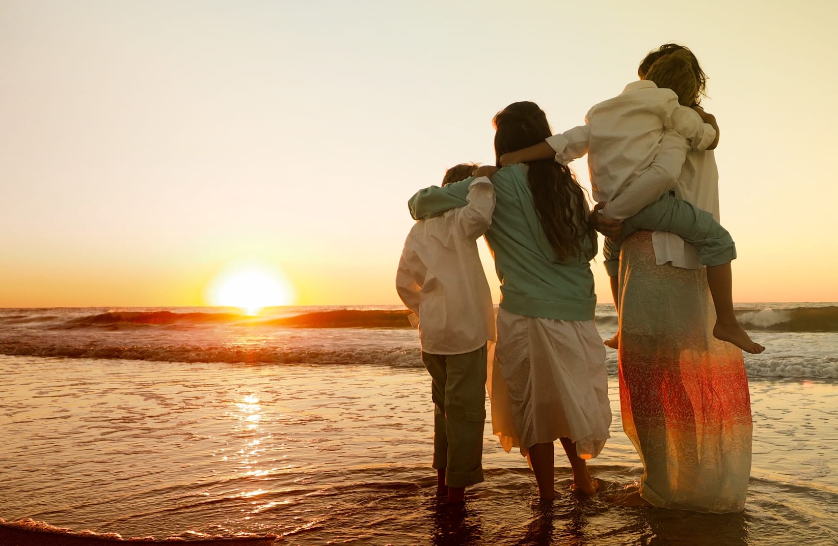 Famille unie au coucher du soleil — coaching parental bienveillant avec Laure Metayer